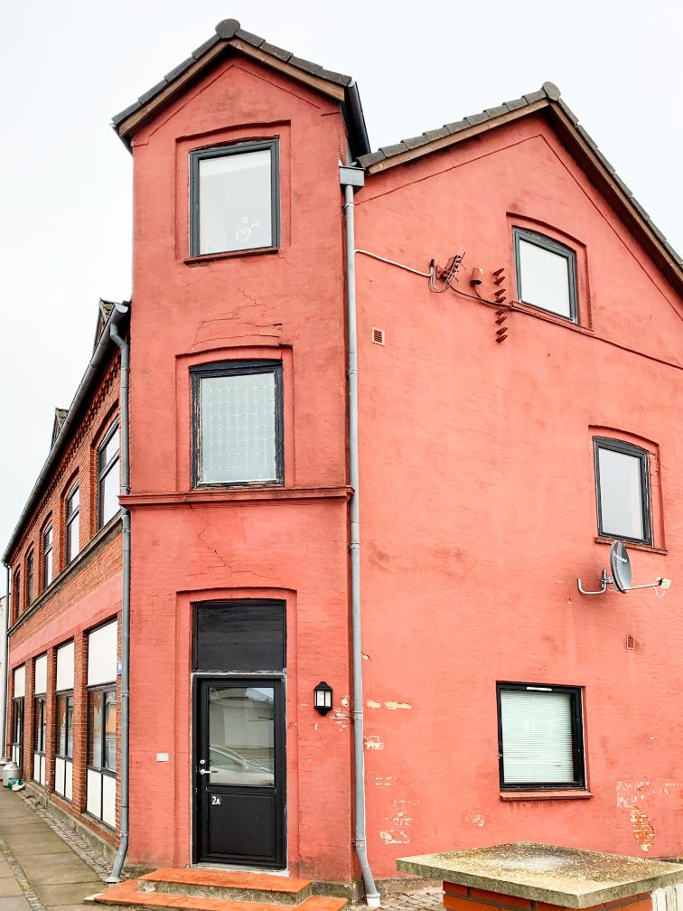 Facaden, som den fremstod før renoveringen. Oprindeligt var den i synlige mursten, men på et tidspunkt blev den pudset op.